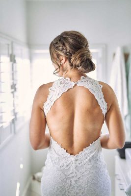 Wedding bride with advance updo hairstyle with a backless wedding gown
